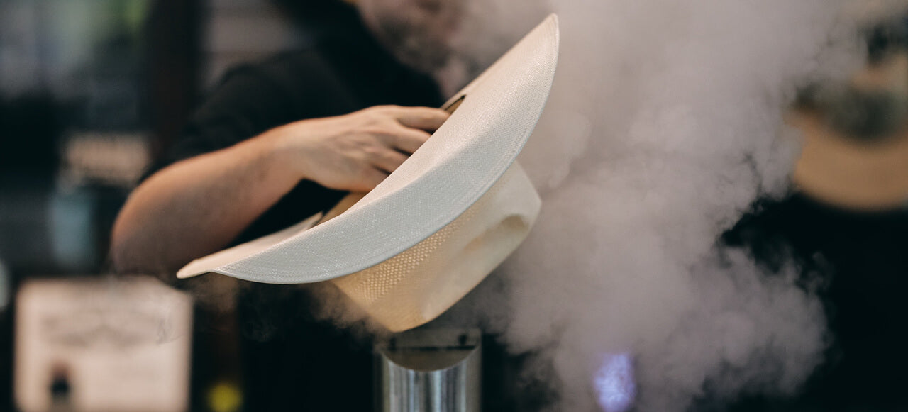Shaping a straw cowboy hat with steam
