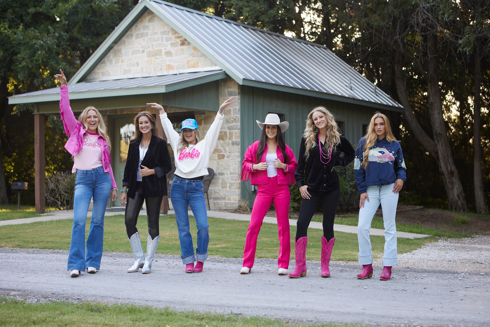 cowgirls wearing pink western wear, pink cowboy boots, and cowboy hats